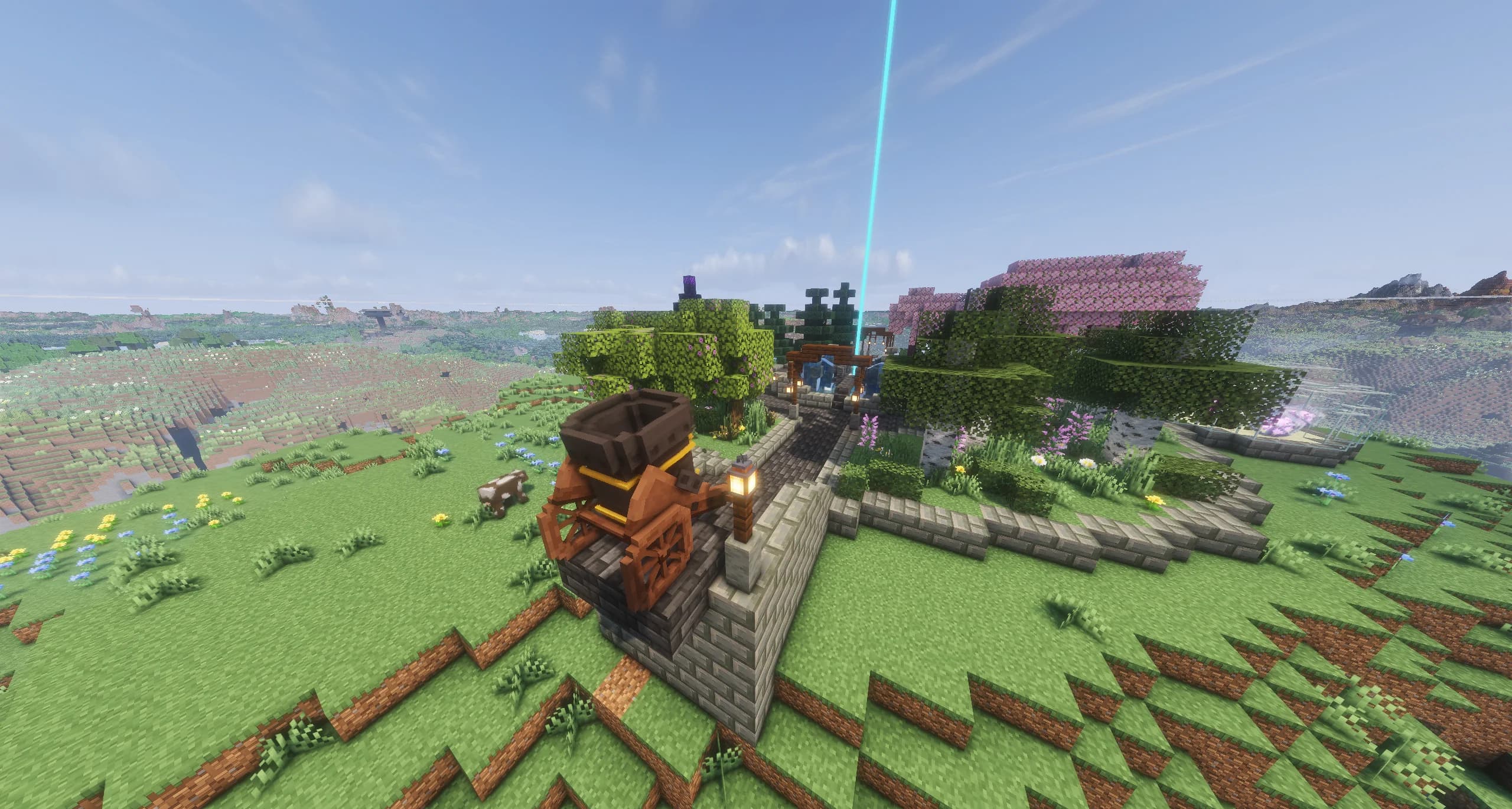 The spawn cannon, a wooden cannon on a stone platform at the edge of spawn, pointing out over the hills, with spawn's fountain and beacon behind it.